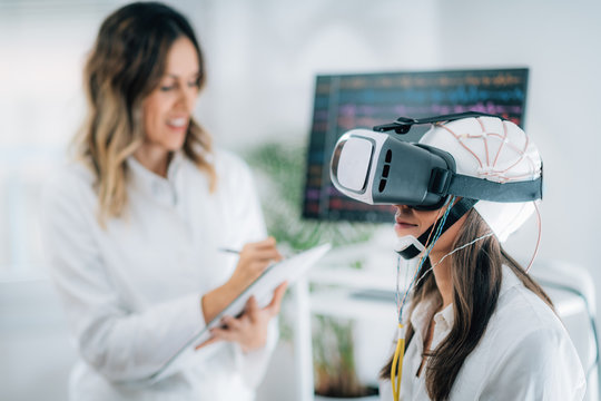 Neuroscience Lab. Patient With Virtual Reality Goggles And EEG Brainwave Cap