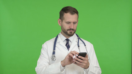 The Young Doctor Using Mobile Phone Against Chroma Key