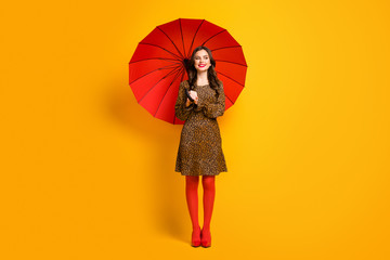 Full length body size view of her she nice-looking attractive lovely pretty charming cheerful cheery wavy-haired girl using umbrella isolated on bright vivid shine vibrant yellow color background © deagreez