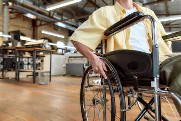 Keep moving. Guy in a wheelchair working in the office