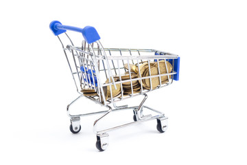 shopping cart with coins on a white background.