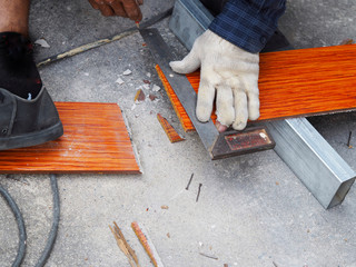 construction worker installing roof tiles