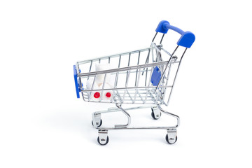 shopping cart with rolls of toilet paper on a white background. isolate