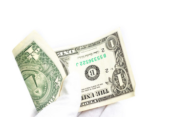 a hand in a white glove holds a one-dollar bill on a white background.
