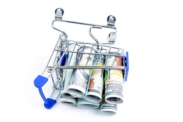 fallen shopping cart with rolls of one hundred dollar bills on a white background, isolate