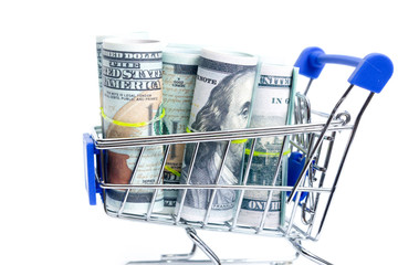 shopping cart with rolls of one hundred dollar bills on a white background, isolate
