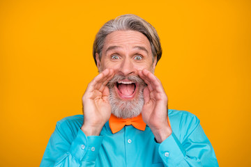 Closeup photo of cool clothes crazy white haired grandpa open mouth shouting sale shopping advert arms near mouth wear blue shirt suspenders bow tie isolated yellow color background