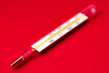 Fototapeta premium mercury thermometer on red background