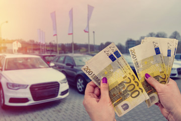 the customer pays euro banknotes for his dream - a new car