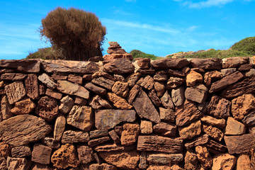 Cala Pregonda, Menorca / Spain - June 23, 2016: A dry stone wall, Menorca, Balearic Islands, Spain