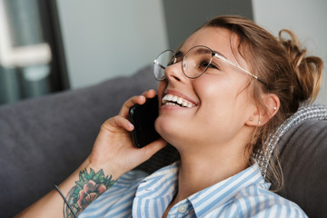 Smiling young businesswoman talking on mobile phone