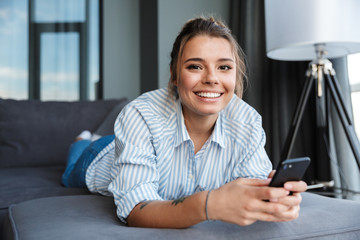 Happy young businesswoman using mobile phone