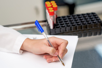 Nurse writes blood diagnosis.