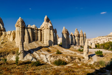 Stone pillars in the Love valley in in Goreme national park. Goreme village, Anatolia, Turkey, Asia.