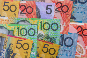 National currency. Colorful australian dollar banknotes on wooden table close up