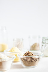 Various gluten free flour corn,sesame,oat,coconut in glass bowl on white background.Alternative to wheat flour for keto paleo diet.Healthy eating,dieting,balanced food concept.Copy space