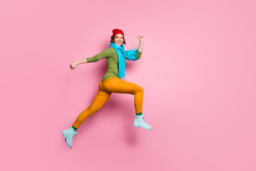 Fototapeta na wymiar Full length profile side photo of cheerful lucky excited girl jump run after season discounts wear red blue headwear footwear isolated over pink color background