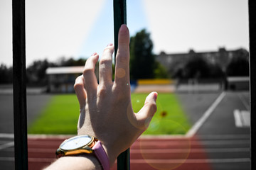 Human hand on the background of the fence