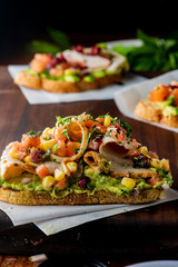 Avocado Toast. Fresh organic avocados mixed with olive oil lemon and salt and pepper paired with radishes micro greens and celery leaves. Spread on whole grain crispy toast. New American favorite.