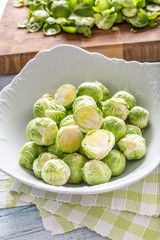 Fresh brusseles sprouts in bowl on kitchen table