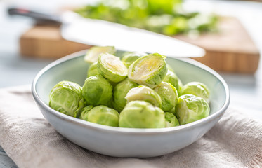 Fresh brusseles sprouts in bowl on kitchen table