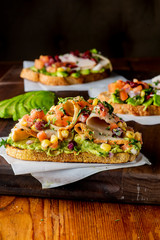 Avocado Toast. Fresh organic avocados mixed with olive oil lemon and salt and pepper paired with radishes micro greens and celery leaves. Spread on whole grain crispy toast. New American favorite.