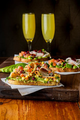 Avocado Toast. Fresh organic avocados mixed with olive oil lemon and salt and pepper paired with radishes micro greens and celery leaves. Spread on whole grain crispy toast. New American favorite.