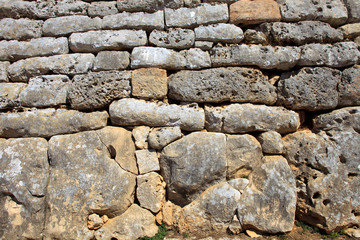 Ciutadela, Menorca / Spain - June 25, 2016: The stones wall of Naveta des Tudons Talaiot culture prehistoric burial site, Ciutadela, Menorca, Balearic Islands, Spain