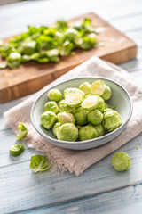 Fresh brusseles sprouts in bowl on kitchen table