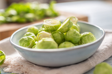 Fresh brusseles sprouts in bowl on kitchen table