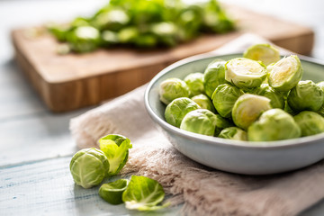 Fresh brusseles sprouts in bowl on kitchen table