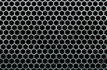 Metal grid with hexagonal cells on a black background