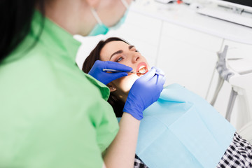 Fototapeta na wymiar Dentist doing dental checkup for his patient