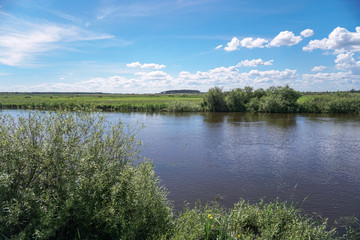 Beautiful spring river in the flowing nature. Colorful landscape in the morning and evening. Travel to deserted places of the world. Stock photo for design