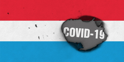 Flag of Luxembourg with burned out hole showing Coronavirus name in it. 2019 - 2020 Novel Coronavirus (2019-nCoV) concept, for an outbreak occurs in the Luxembourg.