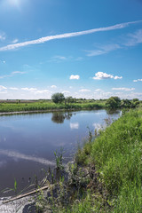 Beautiful spring river in the flowing nature. Colorful landscape in the morning and evening. Travel to deserted places of the world. Stock photo for design