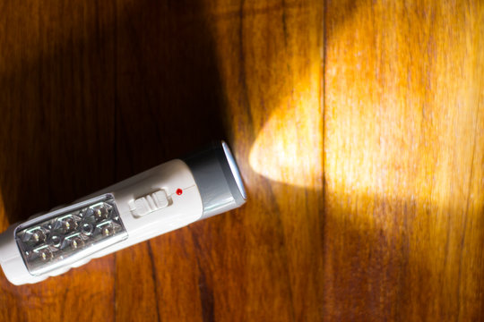 Close up woman hand holding modern flashlight ,LED flashlight.
