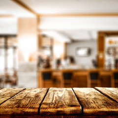 desk of free space and blurred cafe interior. 