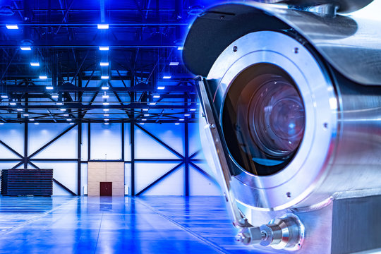 Video Surveillance At An Industrial Enterprise. The Video Camera Captures What Is Happening In The Room Around The Clock. Installation Of A Video Surveillance System In A Warehouse.