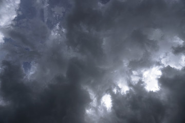 Terrible thunderclouds from the side of a plane. Gloomy epic clouds. Background image in a dark gray style.