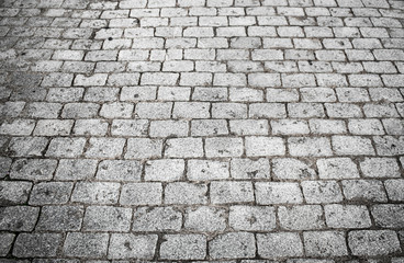 cobbled street with square blocks of gray granite stone. Background