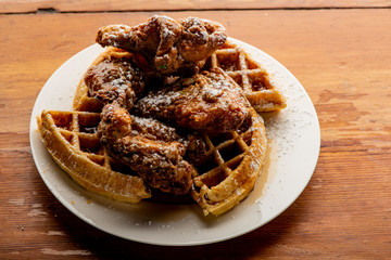 Chicken & waffles. Classic American Diner Style Breakfast or Brunch menu item favorite. Crispy homemade fried chicken on top of home buttermilk waffles topped with butter and maple syrup. 