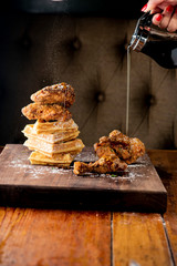 Chicken & waffles. Classic American Diner Style Breakfast or Brunch menu item favorite. Crispy homemade fried chicken on top of home buttermilk waffles topped with butter and maple syrup. 