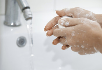 Woman washing hands with soap