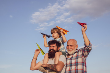 Three different generations ages: grandfather father and child son together. Family holiday and...