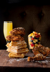 Chicken & waffles. Classic American Diner Style Breakfast or Brunch menu item favorite. Crispy homemade fried chicken on top of home buttermilk waffles topped with butter and maple syrup. 