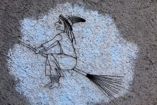 Triora (IM), Italy - February 15, 2017: A witch painted on a wall in the witches village of Triora, Imperia, Liguria, Italy.