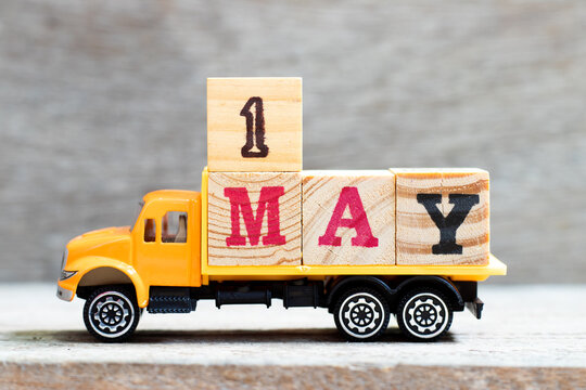 Truck hold letter block in word 1may on wood background (Concept for date 1 month may)