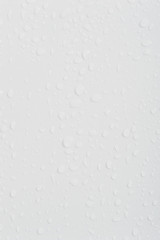 Beautiful water drops at a clean wall in difference sizes from small ones to big ones nice and perfect background for many occasions
