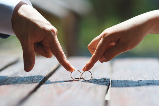couple playing with wedding rings